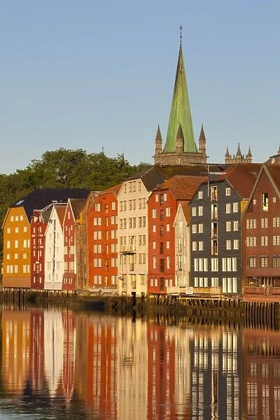 Nidaros Cathedral and old fishing warehouses reflected in the River Nidelva, Trondheim, Sor-Trondelag, Norway, Scandinavia, Europe