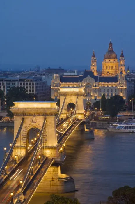 Framed Print : Night view of the Chain Bridge (Szechenyi Lanchid), illuminated, over the River Danube with the Gresham Hotel, St. Stephens basilica, and the Pest side behind, Budapest