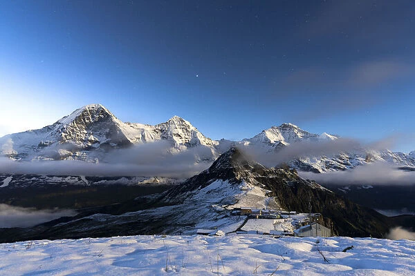 Night view of Eiger, Monch and Jungfrau mountains covered with snow from Mannlichen
