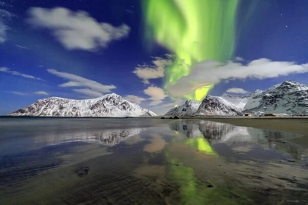 Northern Lights (aurora borealis) and mountains reflected in the cold waters, Skagsanden