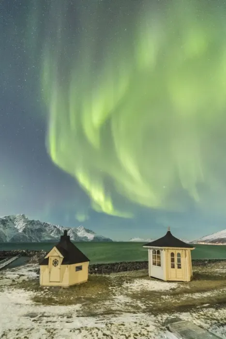 Framed Print : The Northern Lights (aurora borealis) and stars illuminate the wooden huts by icy sea Framed Print : The Northern Lights (aurora borealis) and stars illuminate the wooden huts by icy sea