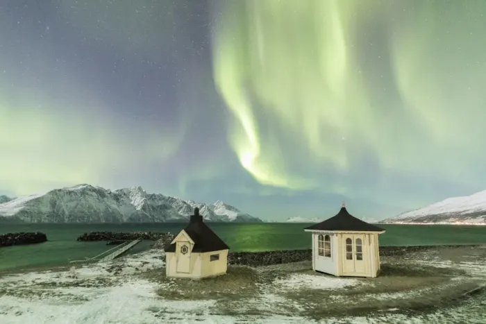 Framed Print : The Northern Lights (aurora borealis) and stars illuminate the wooden huts by icy sea Framed Print : The Northern Lights (aurora borealis) and stars illuminate the wooden huts by icy sea