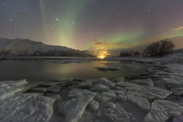 Framed Print : The Northern Lights illuminates the icy landscape in Svensby, Lyngen Alps, Troms