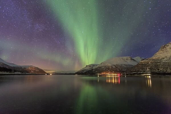 The Northern Lights illuminates the icy sea, Oteren, Storfjorden, Lyngen Alps, Troms