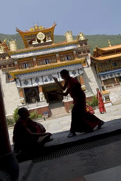 Novice Buddhist monks sparring, Nanwu temple, Kangding, Sichuan, China, Asia