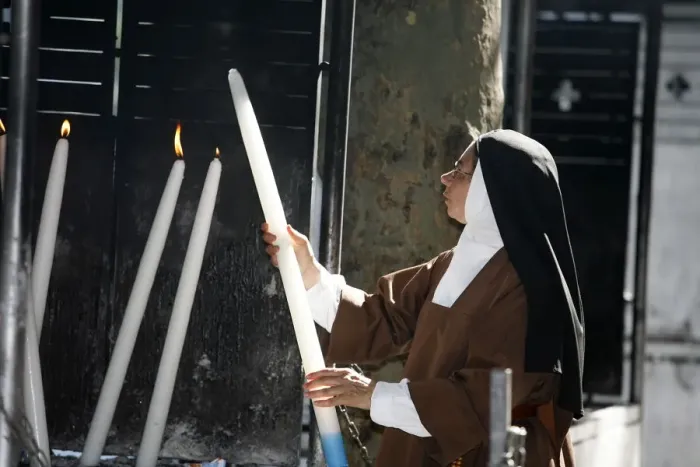 Framed Print : Nun lighting a candle at the Lourdes shrine, Lourdes, Hautes Pyrenees, France, Europe Framed Print : Nun lighting a candle at the Lourdes shrine, Lourdes, Hautes Pyrenees, France, Europe