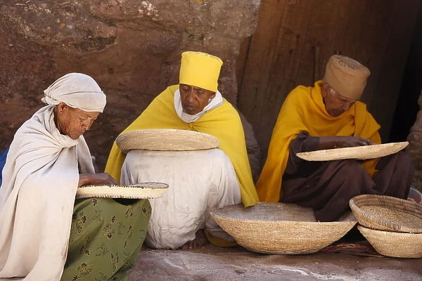 Nuns sorting wheat in Bet Maryam church courtyard, Lalibela, Wollo, Ethiopia, Africa