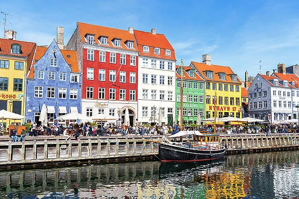 Nyhavn harbour with colourful houses reflected in the waters channel, daytime, Copenhagen, Denmark, Scandinavia, Europe