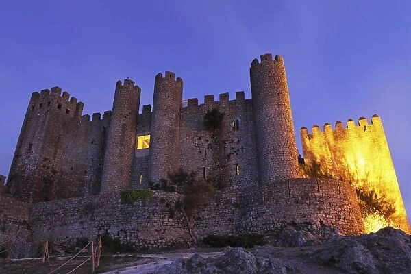 Obidos castle, today used as a luxury Pousada hotel, partially illuminated at night, Obidos, Estremadura, Portugal, Europe