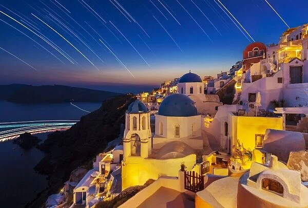 Oia village and churches with star trails after sunset, Santorini (Thira), Cyclades Islands, Greek Islands, Greece, Europe