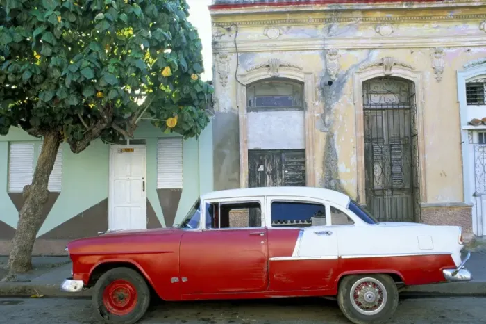 Framed Print : Old American car parked on street beneath fruit tree, Cienfuegos, Cuba Framed Print : Old American car parked on street beneath fruit tree, Cienfuegos, Cuba