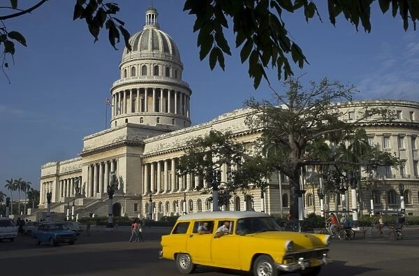 Old American car passing the Capitolio Nacional, Havana, Cuba, West Indies