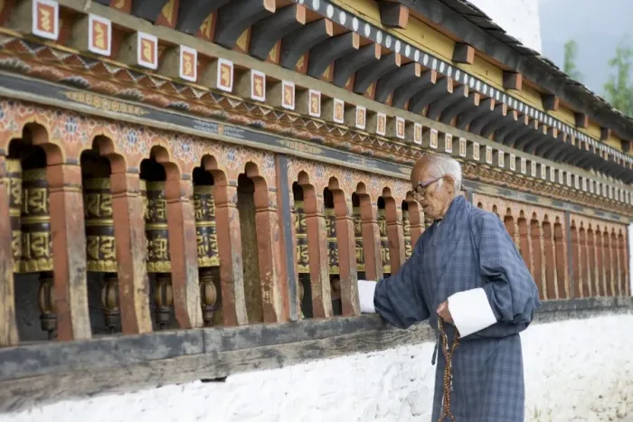 Framed Print : Old Bhutanese man turning prayer wheels in Buddhist temple, Thimphu, Bhutan, Asia