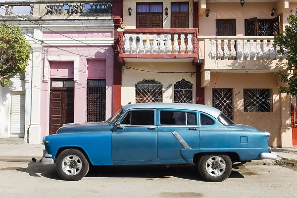 Old blue American car parked in front of old buildings, Cienfuegos, UNESCO World Heritage Site
