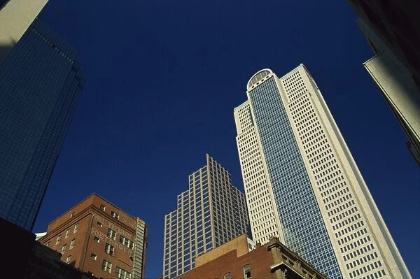 Old brick building contrasts with modern skyscrapers in Dallas