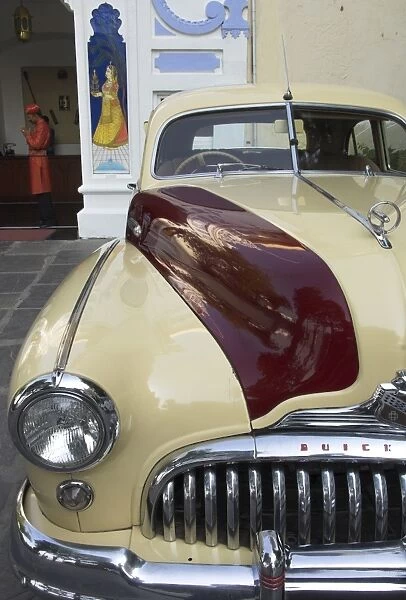Old Buick car in front of entrance to the City Palace Hotel