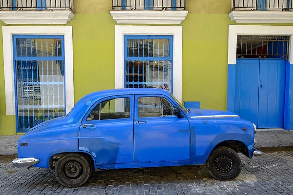 Old car parked in front of a colorful building, Old Havana, Cuba, West Indies