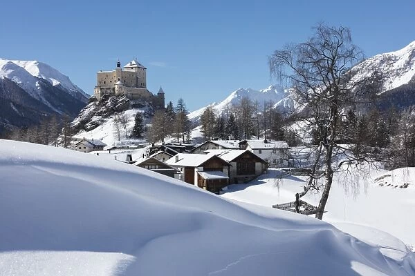 Old castle and alpine village of Tarasp surrounded by snowy peaks, Inn district