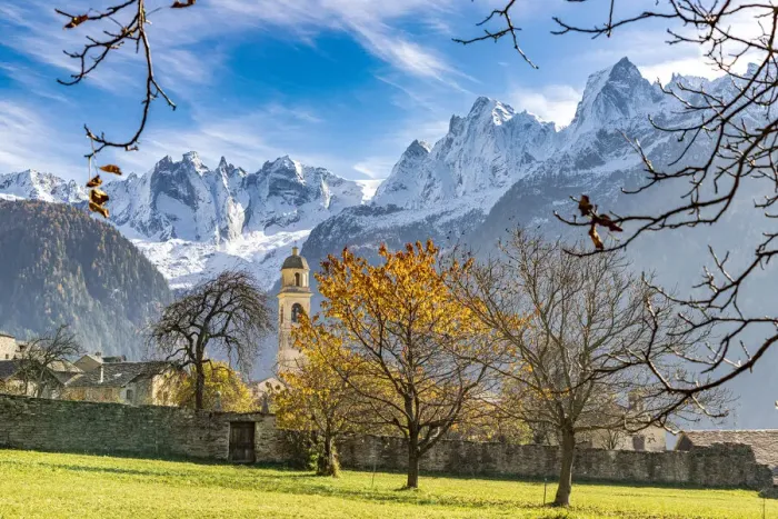Framed Print : Old church lit by autumn colors with snowcapped Piz Badile and Cengalo in the background, Soglio, Graubunden, Switzerland, Europe Framed Print : Old church lit by autumn colors with snowcapped Piz Badile and Cengalo in the background, Soglio, Graubunden, Switzerland, Europe