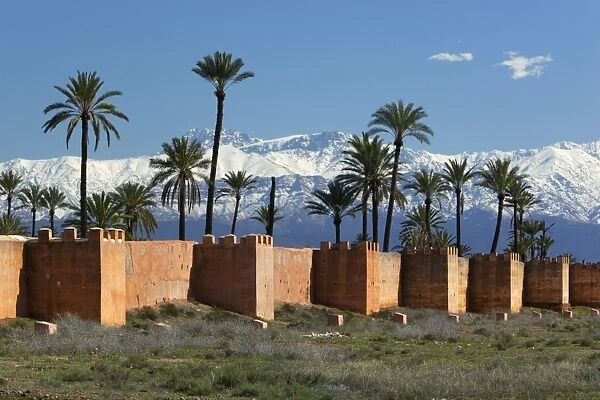 The old city walls and snow capped Atlas Mountains, Marrakech, Morocco, North Africa, Africa