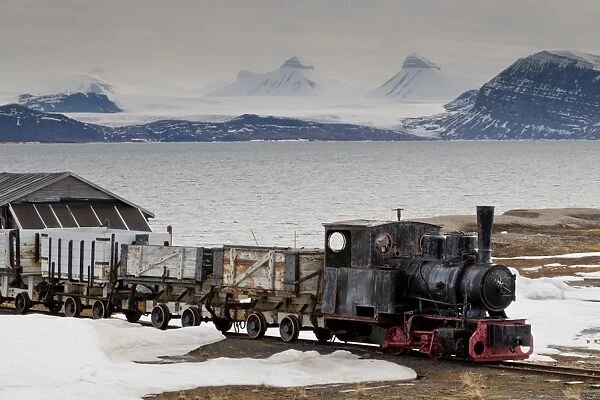Old coal train with snow, fjord and mountains, Ny Alesund, Spitsbergen (Svalbard), Arctic, Norway, Scandinavia, Europe