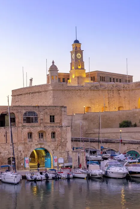 Framed Print : The Old Dock Buildings at Bormla Waterfront with Fort St. Michael Clock Tower in the background at dusk, Cospicua, Malta Framed Print : The Old Dock Buildings at Bormla Waterfront with Fort St. Michael Clock Tower in the background at dusk, Cospicua, Malta