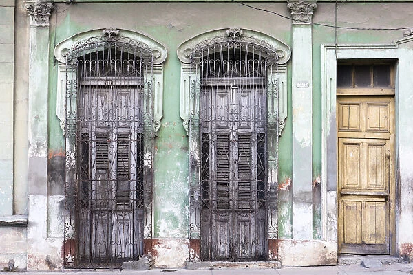 Old doorways and windows, covered by intricate metal gates, Cienfuegos, UNESCO World Heritage Site