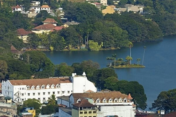 The old-fashioned white Queens Hotel by the famous lake in the old Sinhalese hill country capital, Kandy, Sri