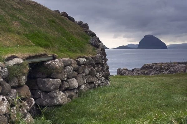 Old fisherman hut and Koltur island, from Kirkjubour, Streymoy, Faroe Islands (Faroes)