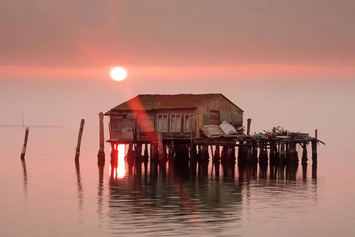Framed Print : Old fishermens shack at sunset in Venetian lagoon off the coast of Pellestrina, Venice