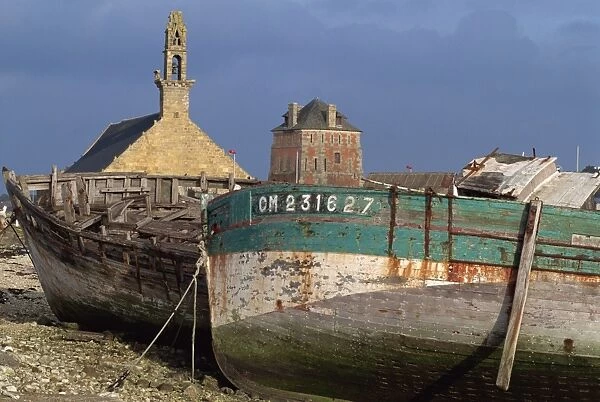 Old fishing boats in front of the Rocamadour chapel and Vauban tower at Camaret