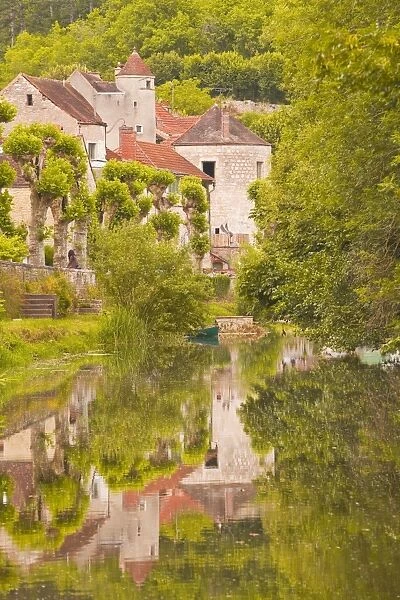 Old houses of the village of Noyers sur Serein reflecting in the River Serein, Yonne, Burgundy, France, Europe
