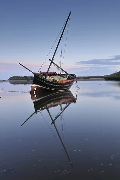 Old ketch reflecting in Aln Estuary as tide rises, Alnmouth, Northumberland