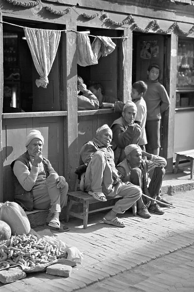 Old men and boys outside a cafe