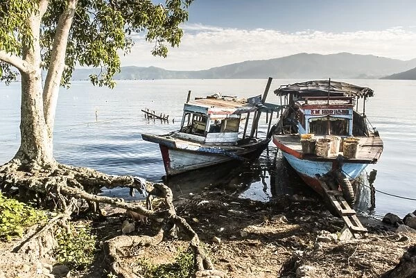 Old rusty fishing boats in a village at Lake Toba (Danau Toba), North Sumatra, Indonesia
