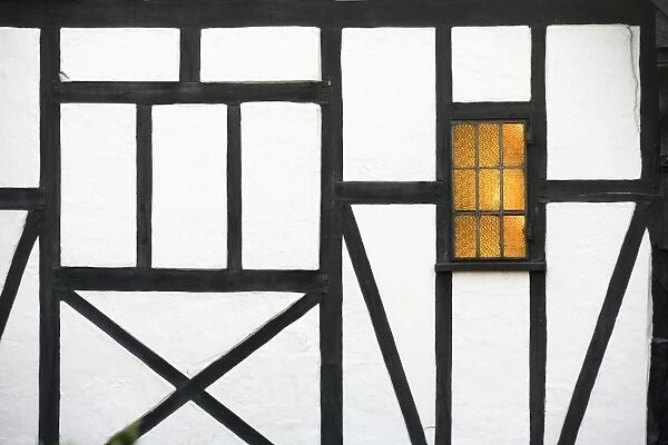 Old timber framed house with light in window, Chilham, Kent, England, United Kingdom