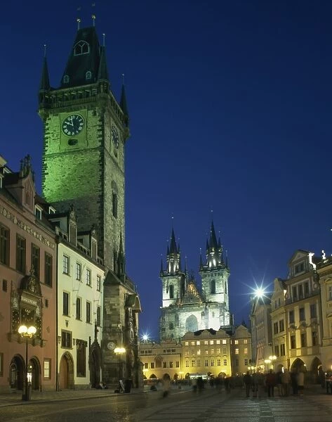 The Old Town Hall and Gothic Tyn church illuminated at night in the city of Prague
