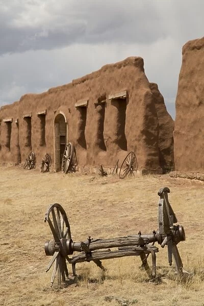 Old wagon wheels with remnants of Fort Union behind, Fort Union National Monument, New Mexico, United States of America, North America