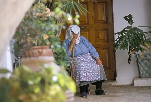 Old woman dozing at monastery