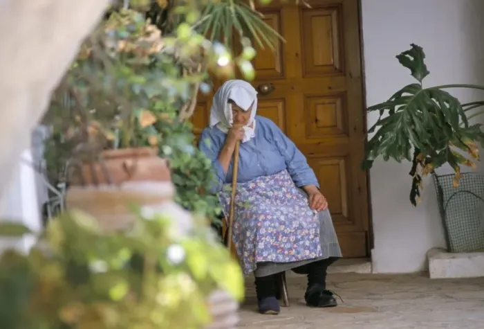 Framed Print : Old woman dozing at monastery Framed Print : Old woman dozing at monastery