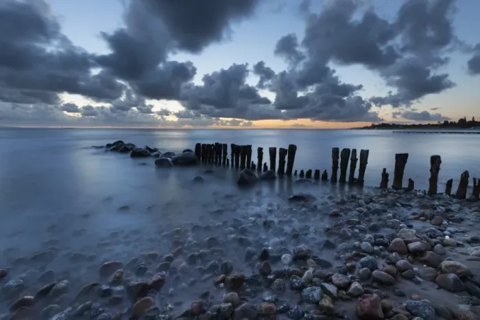 Framed Print : Old wooden piles going out to sea and pebbles on beach at dawn, Munkerup, Kattegat Coast Framed Print : Old wooden piles going out to sea and pebbles on beach at dawn, Munkerup, Kattegat Coast