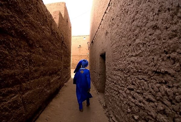 Omar walks through his home town, just south of Mahmid, Morocco, North Africa, Africa
