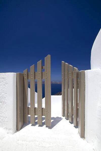 Open gate and view at Oia, Santorini, Cyclades, Greek Islands, Greece, Europe