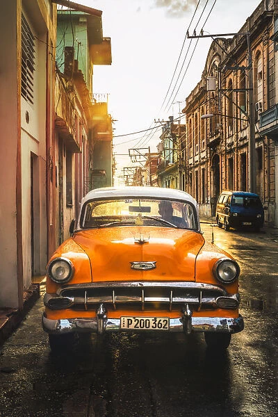 Orange American vintage car at sunset, La Habana (Havana), Cuba, West Indies, Caribbean