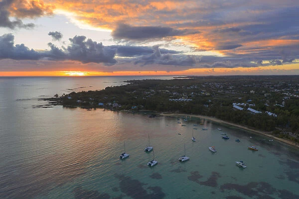 Orange sky at sunrise over the tropical beach and lagoon, aerial view, Grand Baie