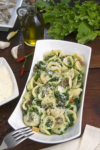 Orecchiette (little ears), a type of pasta of Apulia, with broccoli rabe and salted fish