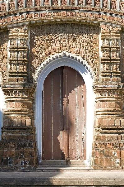 Ornate carving of Hindu myths above a door in the restored miniature terracotta Hindu temple in Baranagar, rural West Bengal