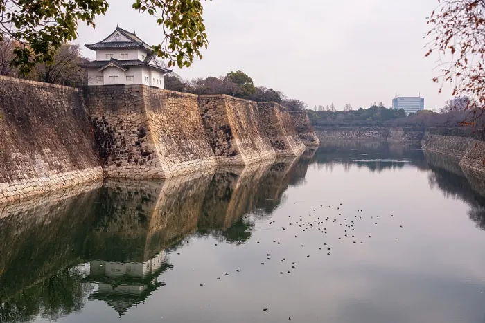 Framed Print : Osaka Castle in Japan. Overlooking the stone moat and reflecting water at Rokuban-yagura Turret on the outer walls.Framed by late autumanl foliage Framed Print : Osaka Castle in Japan. Overlooking the stone moat and reflecting water at Rokuban-yagura Turret on the outer walls.Framed by late autumanl foliage