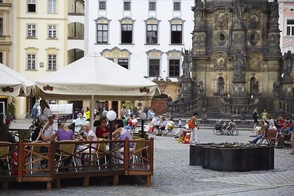 Outdoor cafe in Upper Square (Horni Namesti), with Holy Trinity Column