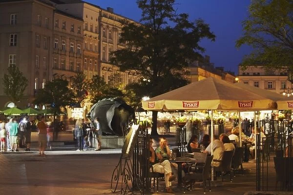 Outdoor cafes in Main Market Square (Rynek Glowny) at dusk, Krakow, Poland, Europe